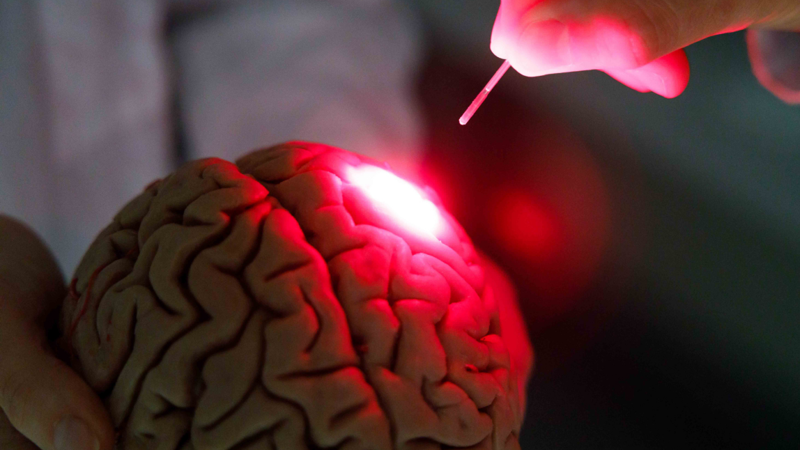 Low-power laser and LED [hotobiomodulation device to attenuate Parkison's symtoms